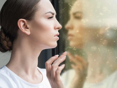 Woman looking out the window and there is air pollution outside