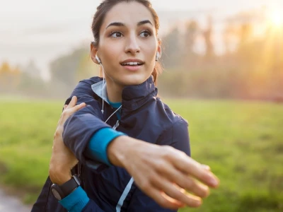 Happy woman exercising outside the house