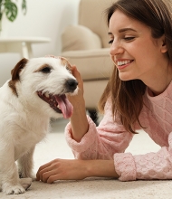 A woman pets her dog