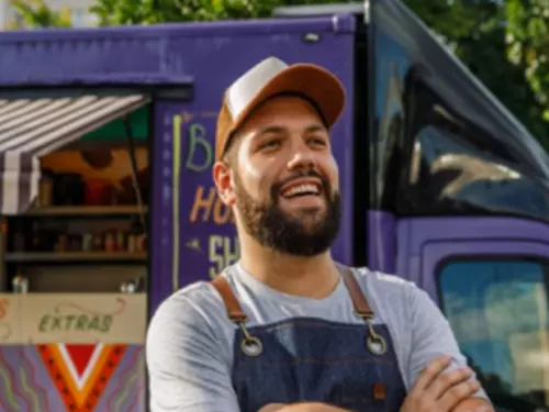 Man standing outside smiling confidently